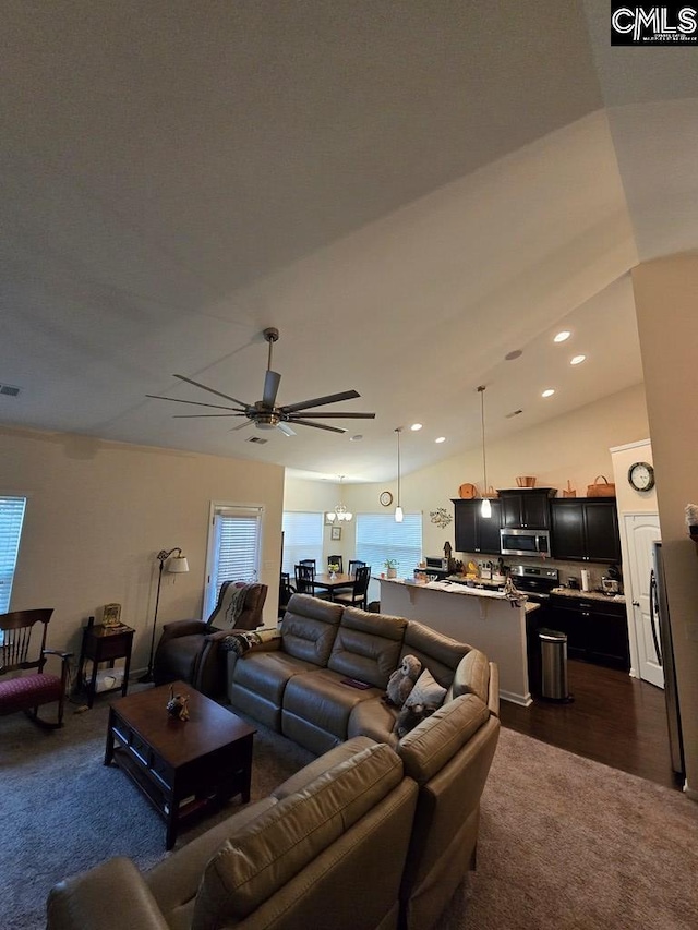 living room featuring vaulted ceiling, ceiling fan, and dark wood-type flooring