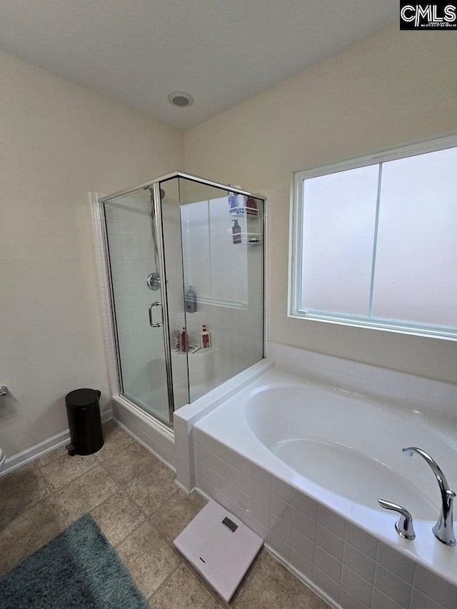 bathroom with tile patterned floors and separate shower and tub