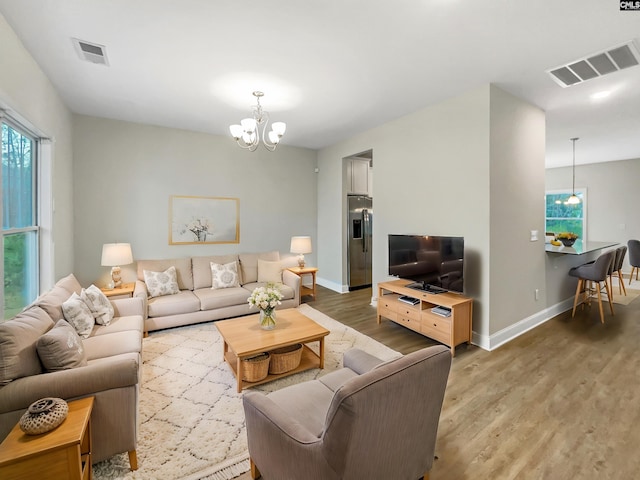 living room featuring a chandelier and hardwood / wood-style flooring