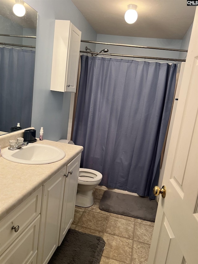 bathroom featuring tile patterned flooring, vanity, toilet, and a shower with shower curtain