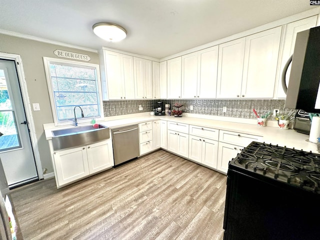 kitchen with light wood-type flooring, stainless steel dishwasher, black gas range oven, sink, and white cabinets