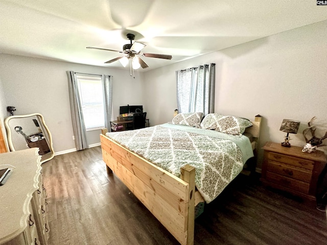 bedroom with ceiling fan and dark hardwood / wood-style floors