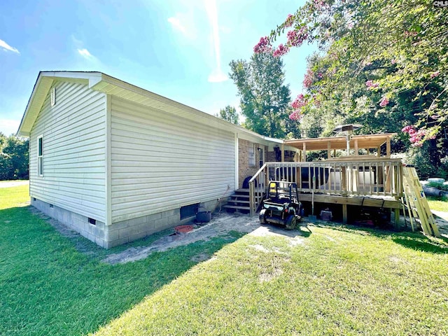 rear view of property featuring a deck and a yard