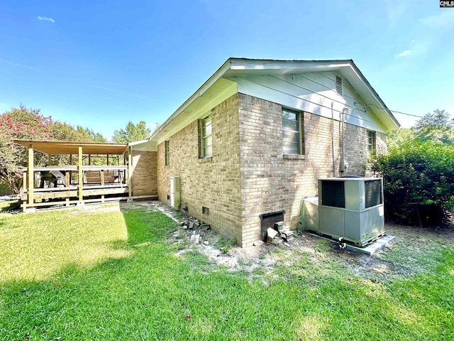 view of home's exterior featuring a yard and a deck