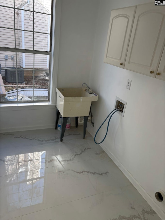 laundry room featuring washer hookup, cabinets, and sink