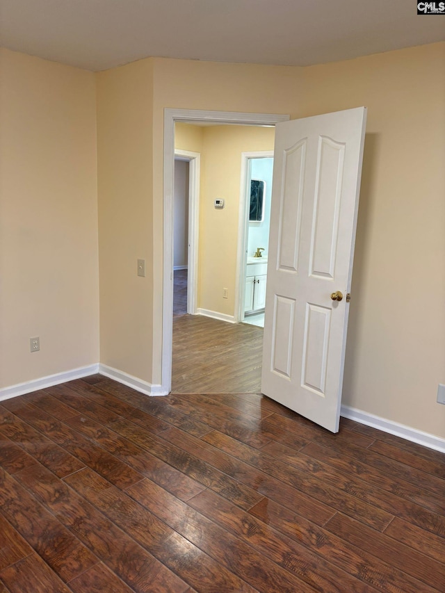 spare room with dark hardwood / wood-style floors