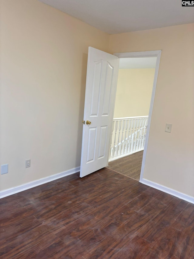 empty room with dark wood-type flooring