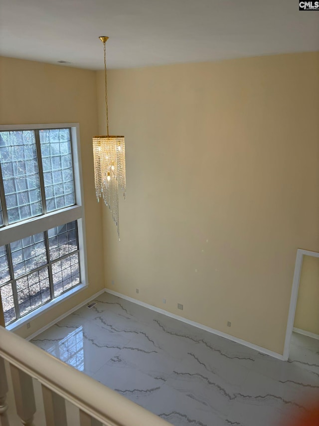 interior space with a chandelier and a wealth of natural light