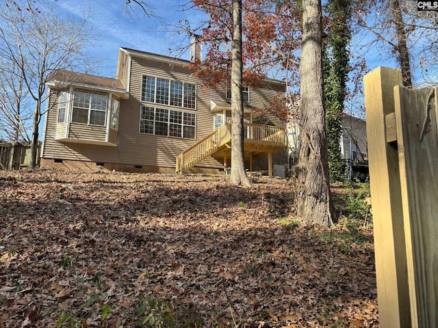 rear view of house with a wooden deck