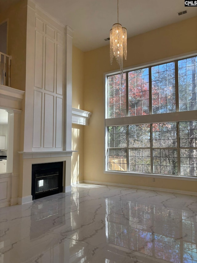 unfurnished living room with a notable chandelier