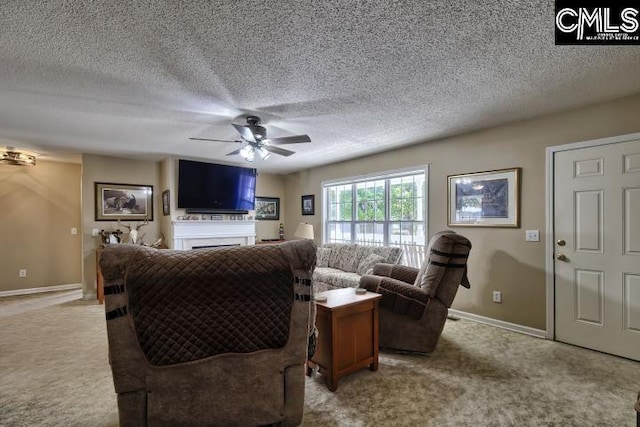 living room with ceiling fan, light colored carpet, and a textured ceiling