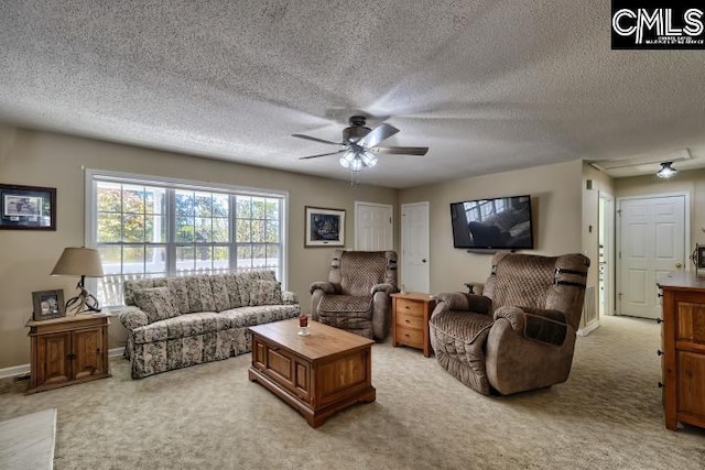 carpeted living room with ceiling fan and a textured ceiling