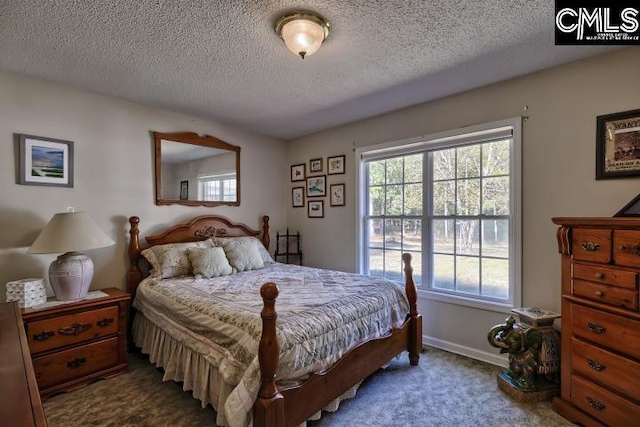 carpeted bedroom featuring a textured ceiling