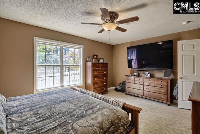 bedroom with carpet flooring, a textured ceiling, and ceiling fan