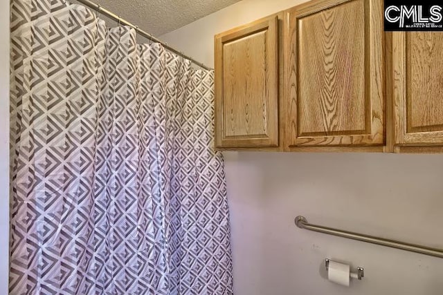 bathroom with a textured ceiling