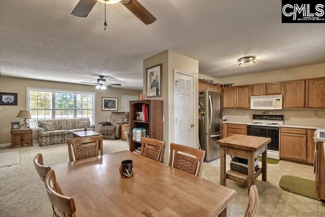 dining room featuring a textured ceiling and ceiling fan