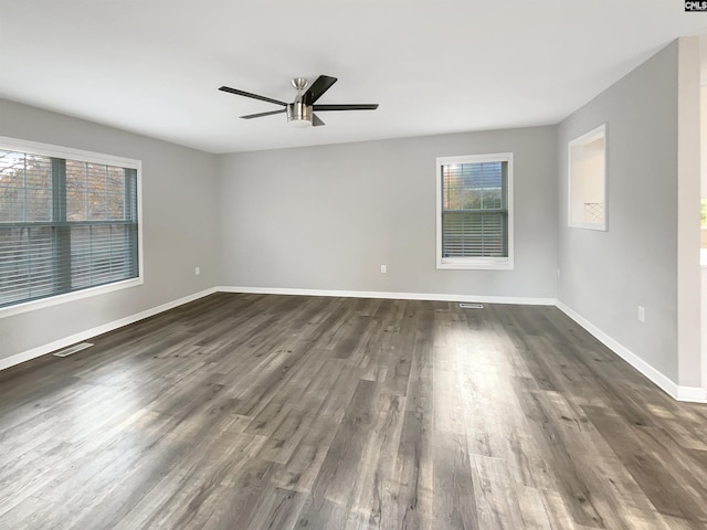 empty room featuring ceiling fan and dark hardwood / wood-style flooring