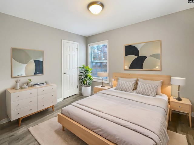 bedroom with dark hardwood / wood-style floors