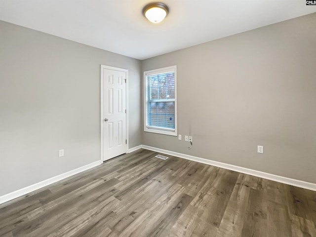 spare room with dark hardwood / wood-style flooring