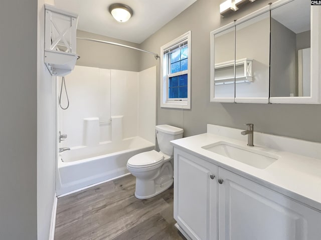 full bathroom featuring hardwood / wood-style floors, vanity, bathtub / shower combination, and toilet