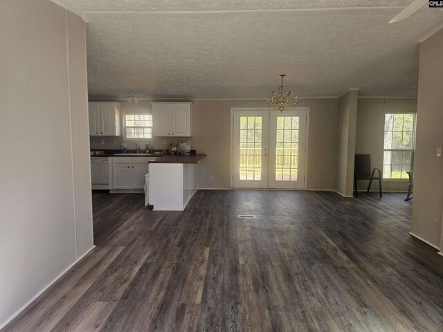1611 Carolina Ln, Beaufort, SC 29906 - kitchen with an inviting chandelier, white dishwasher, dark hardwood / wood-style floors, a textured ceiling, and white cabinetry
