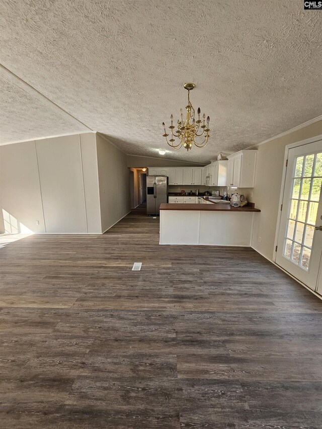1611 Carolina Ln, Beaufort, SC 29906 - unfurnished living room with a chandelier, crown molding, dark wood-type flooring, and a textured ceiling