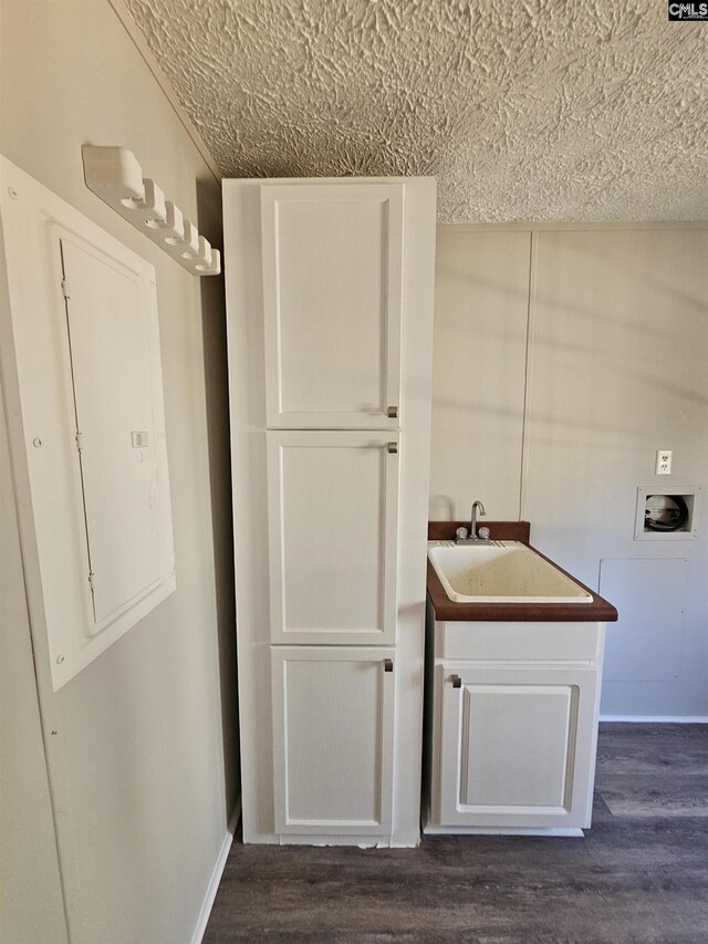 1611 Carolina Ln, Beaufort, SC 29906 - kitchen with white cabinets, dark hardwood / wood-style flooring, electric panel, and sink