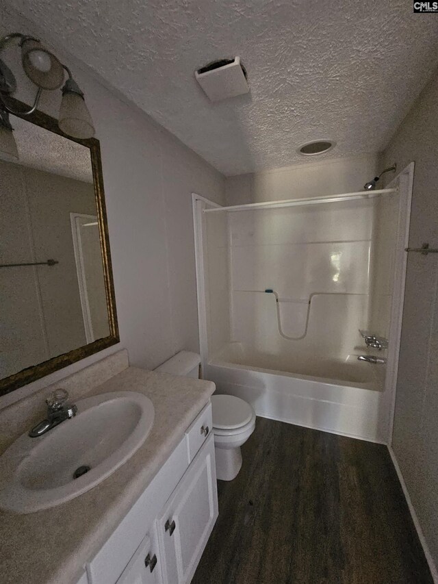 1611 Carolina Ln, Beaufort, SC 29906 - full bathroom with shower / tub combination, hardwood / wood-style floors, a textured ceiling, and toilet