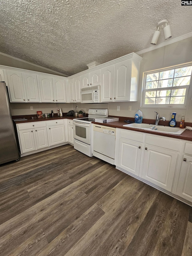 1611 Carolina Ln, Beaufort, SC 29906 - kitchen with white appliances, lofted ceiling, white cabinets, sink, and dark hardwood / wood-style floors