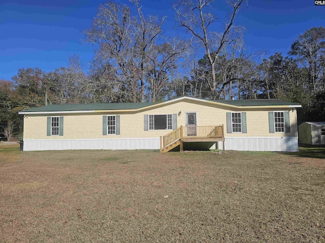 1611 Carolina Ln, Beaufort, SC 29906 - manufactured / mobile home with a front lawn and a storage unit