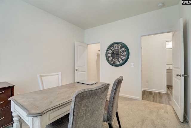 dining area featuring light colored carpet