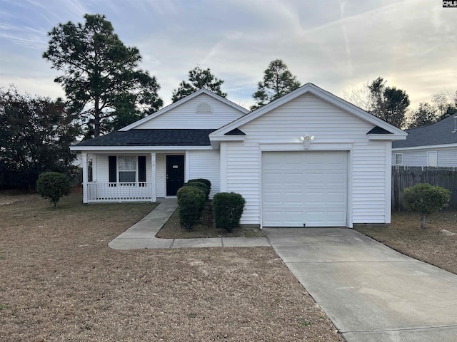 single story home featuring a lawn, a garage, and covered porch