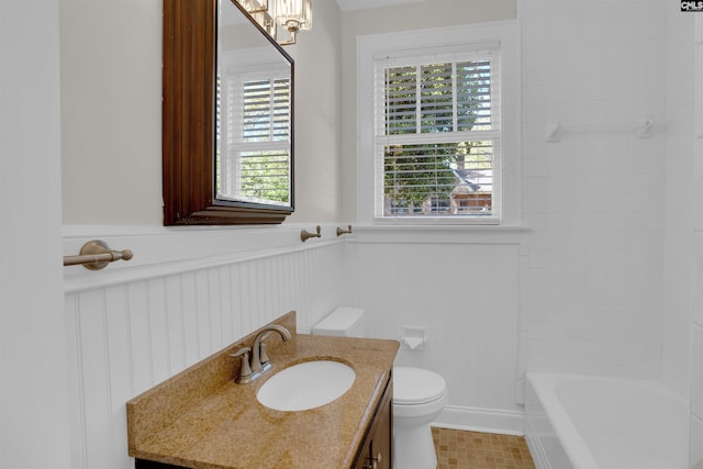 bathroom with vanity, toilet, and a bathtub