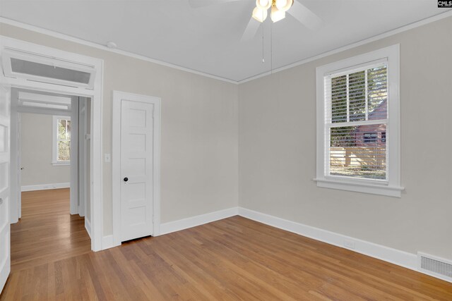 spare room featuring ceiling fan, ornamental molding, and light hardwood / wood-style flooring