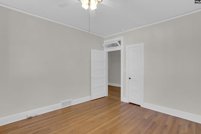 spare room with hardwood / wood-style floors, ceiling fan, and ornamental molding