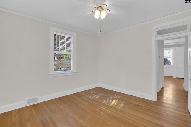 unfurnished room featuring hardwood / wood-style floors, ceiling fan, and crown molding