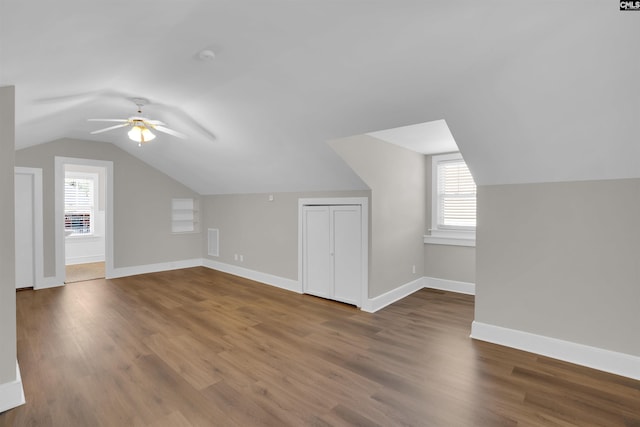 additional living space featuring hardwood / wood-style flooring, ceiling fan, and lofted ceiling