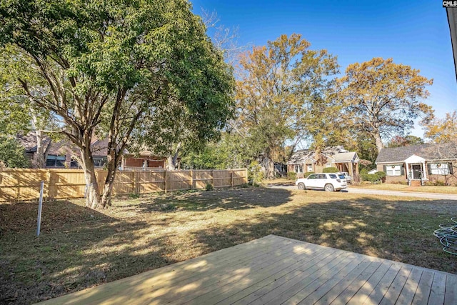 wooden terrace featuring a yard