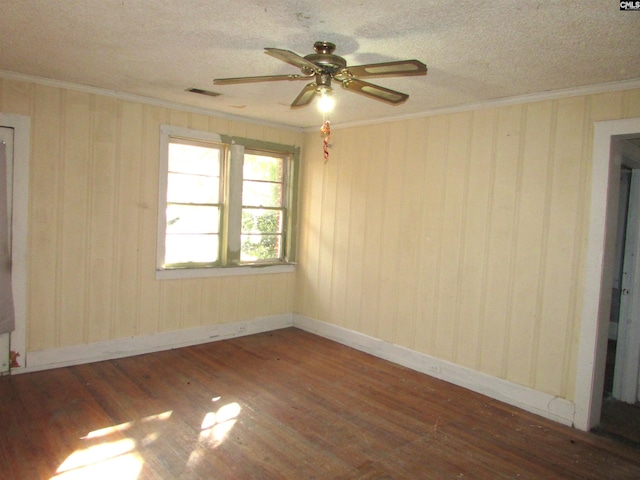 unfurnished room with a textured ceiling, ceiling fan, crown molding, and dark hardwood / wood-style floors