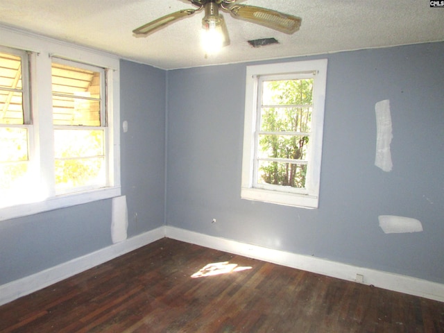 unfurnished room with a textured ceiling, dark hardwood / wood-style flooring, and ceiling fan