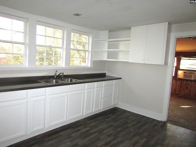 kitchen featuring dark hardwood / wood-style flooring, white cabinets, and sink