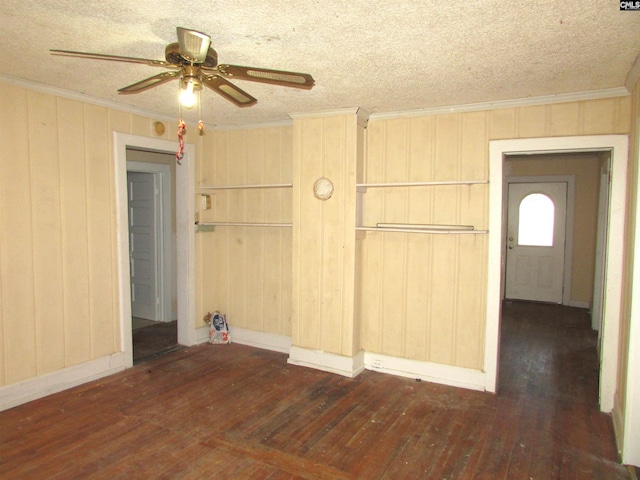 unfurnished room with ceiling fan, dark hardwood / wood-style flooring, and a textured ceiling