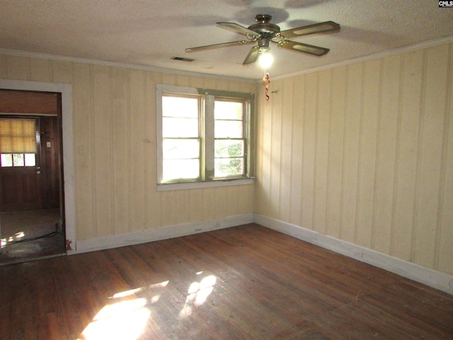 spare room with dark hardwood / wood-style flooring, plenty of natural light, and ornamental molding