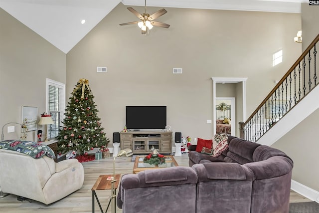 living room featuring ceiling fan, high vaulted ceiling, and light hardwood / wood-style floors