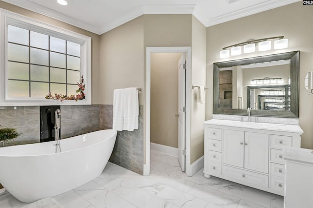 bathroom featuring a bathing tub, vanity, tile walls, and ornamental molding