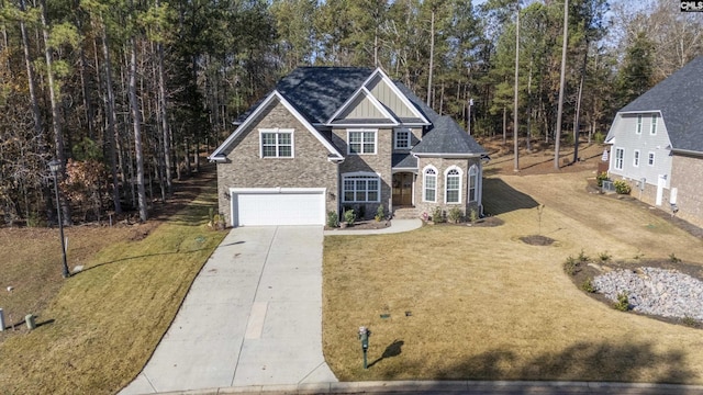 view of front of home with a front yard and a garage