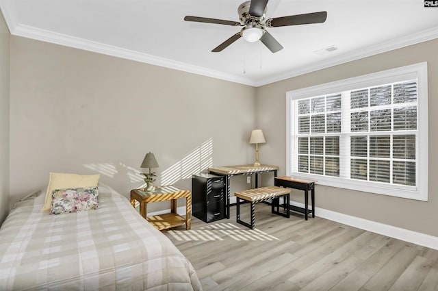 bedroom featuring ceiling fan, light wood-type flooring, and crown molding