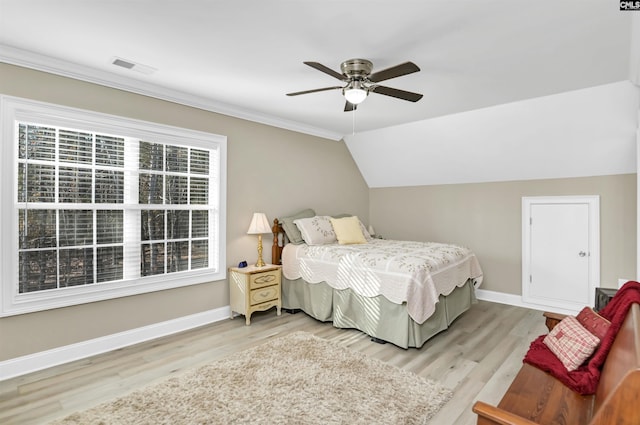 bedroom with ceiling fan, vaulted ceiling, and light hardwood / wood-style flooring