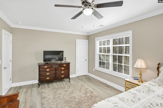 bedroom featuring ceiling fan, ornamental molding, and light wood-type flooring