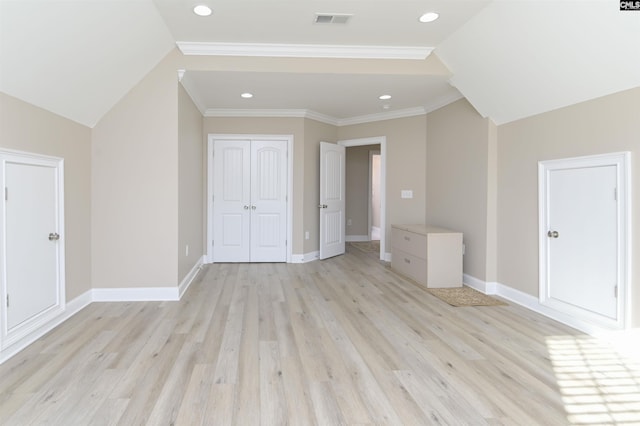 additional living space featuring light hardwood / wood-style floors and lofted ceiling